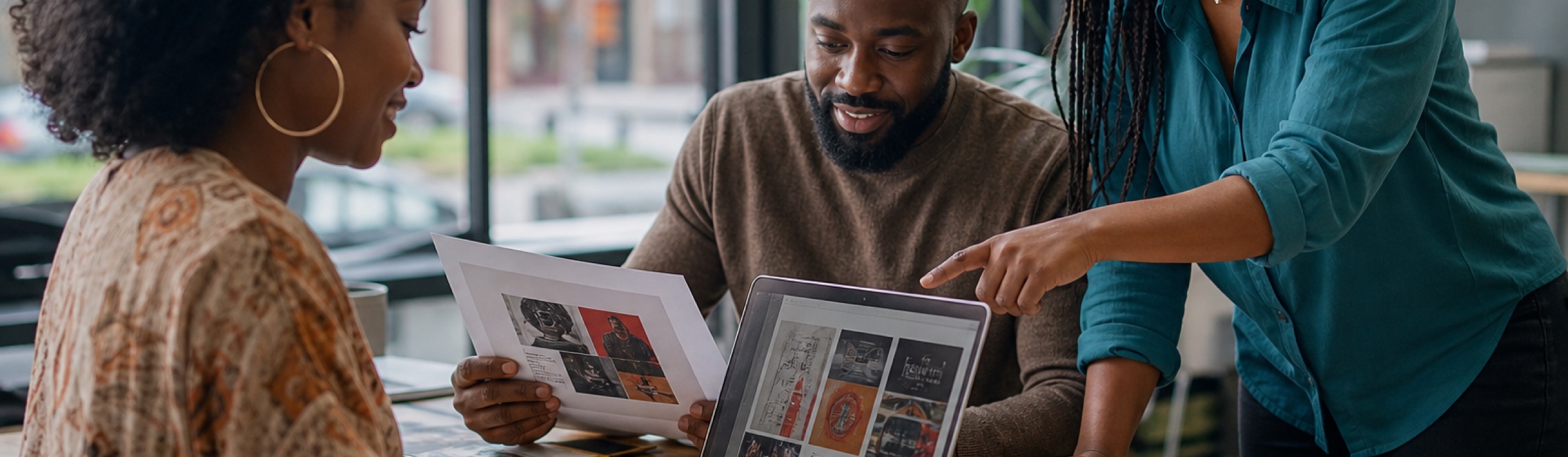 African American business owners collaborating at a laptop to design a new listing and advertisement